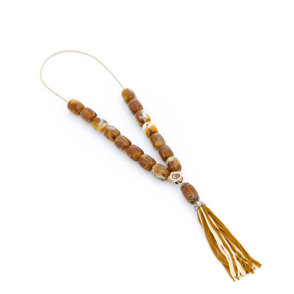 handmade resin worry bead in brown shades with a tassel