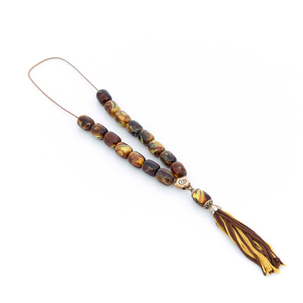 handmade resin worry bead in brown and yellow shades with a tassel