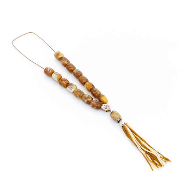 handmade resin worry bead in light brown and yellow shades with a tassel